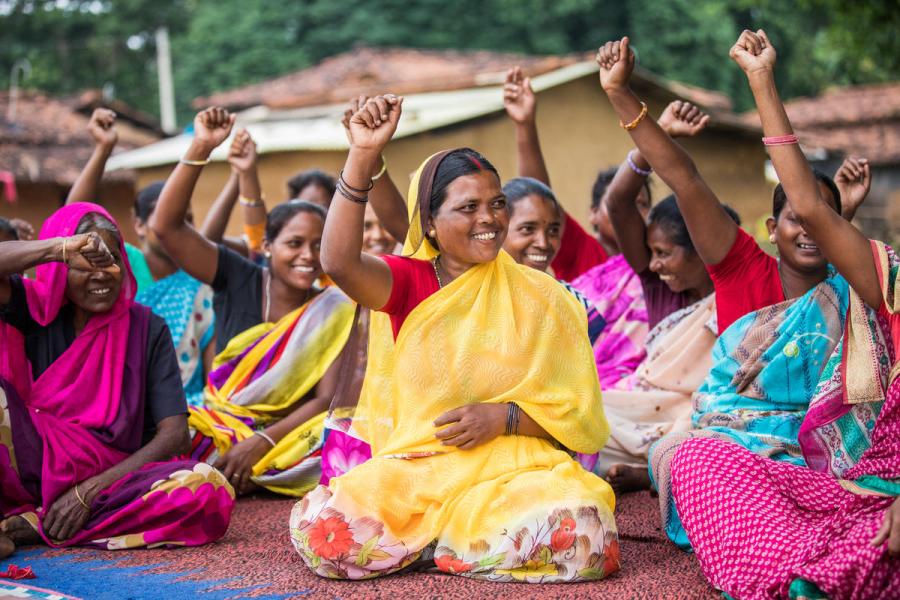 group of women with raised fists participating in a local self-government meeting