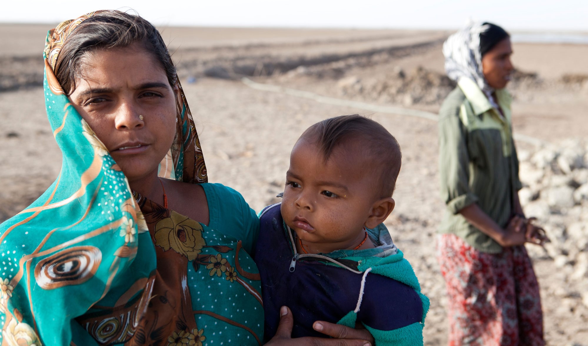 woman holding child in her arms