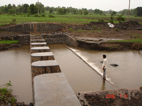 A man surveys a check dam-groundwater water crisis