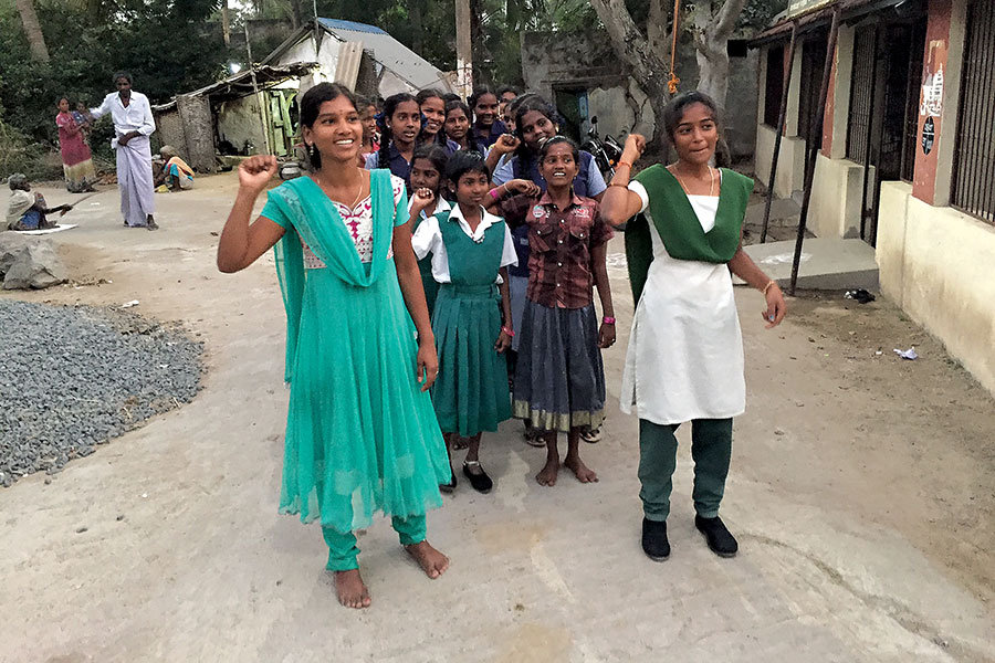 2 women and several young girls peacefully protesting