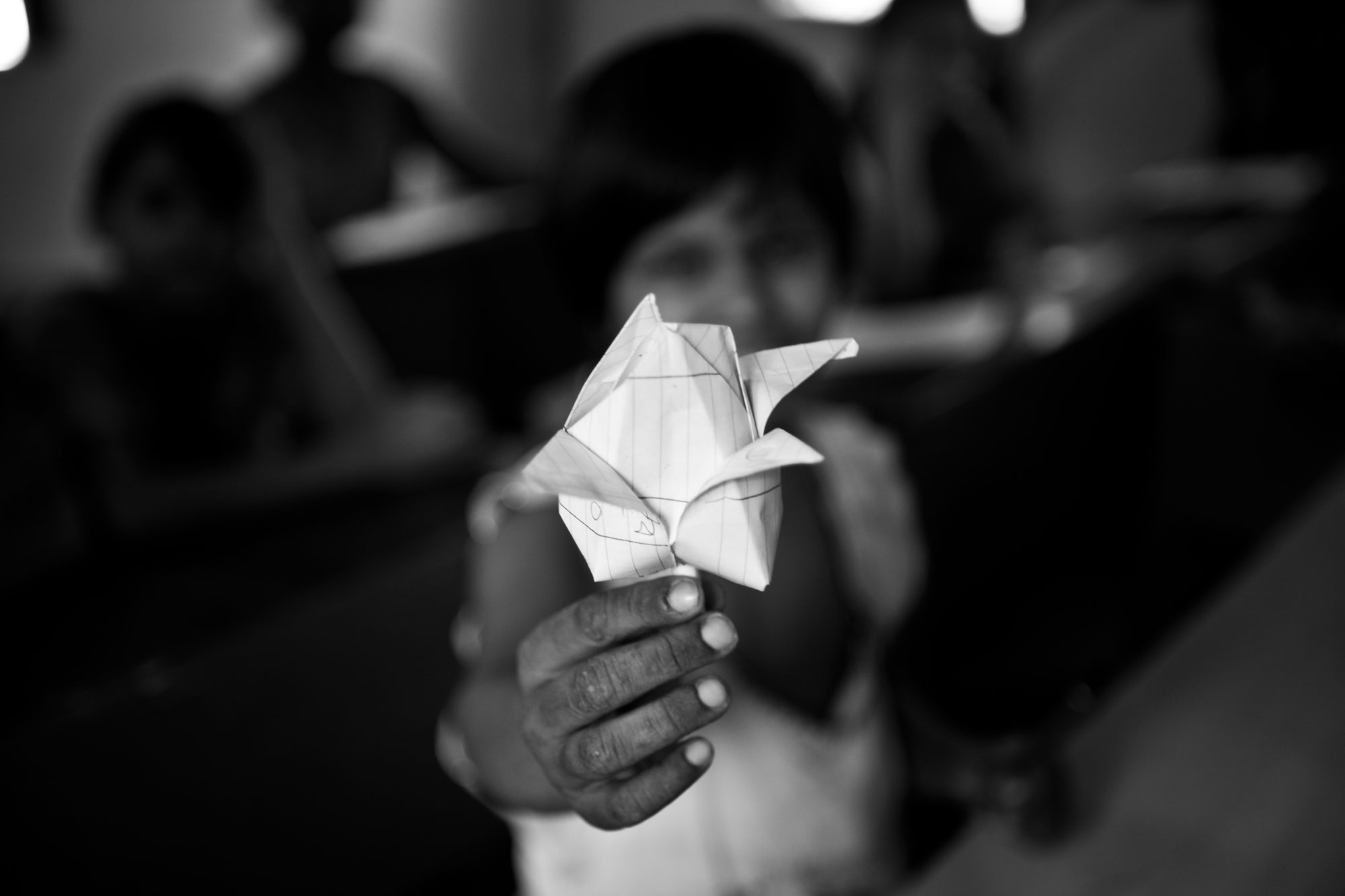 A child offering a paper flower_human trafficking_uma sanjog