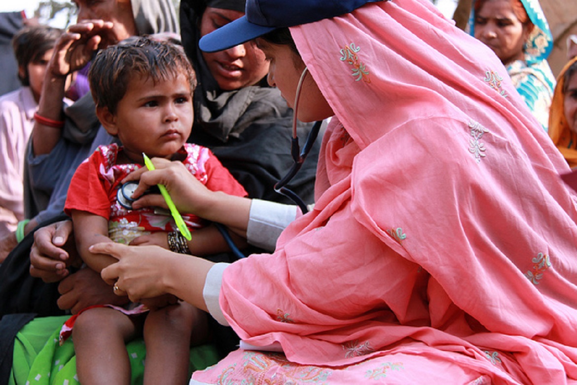 A female doctor examining a young boy