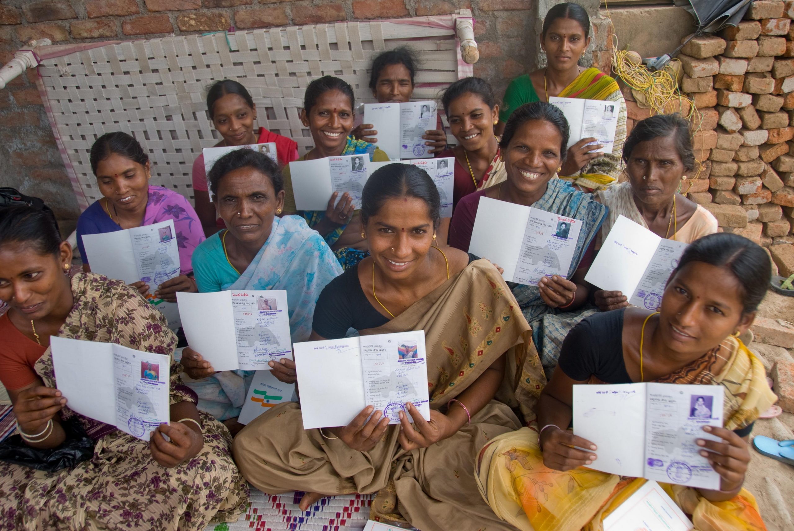 a group of women holding some kind of a personal document