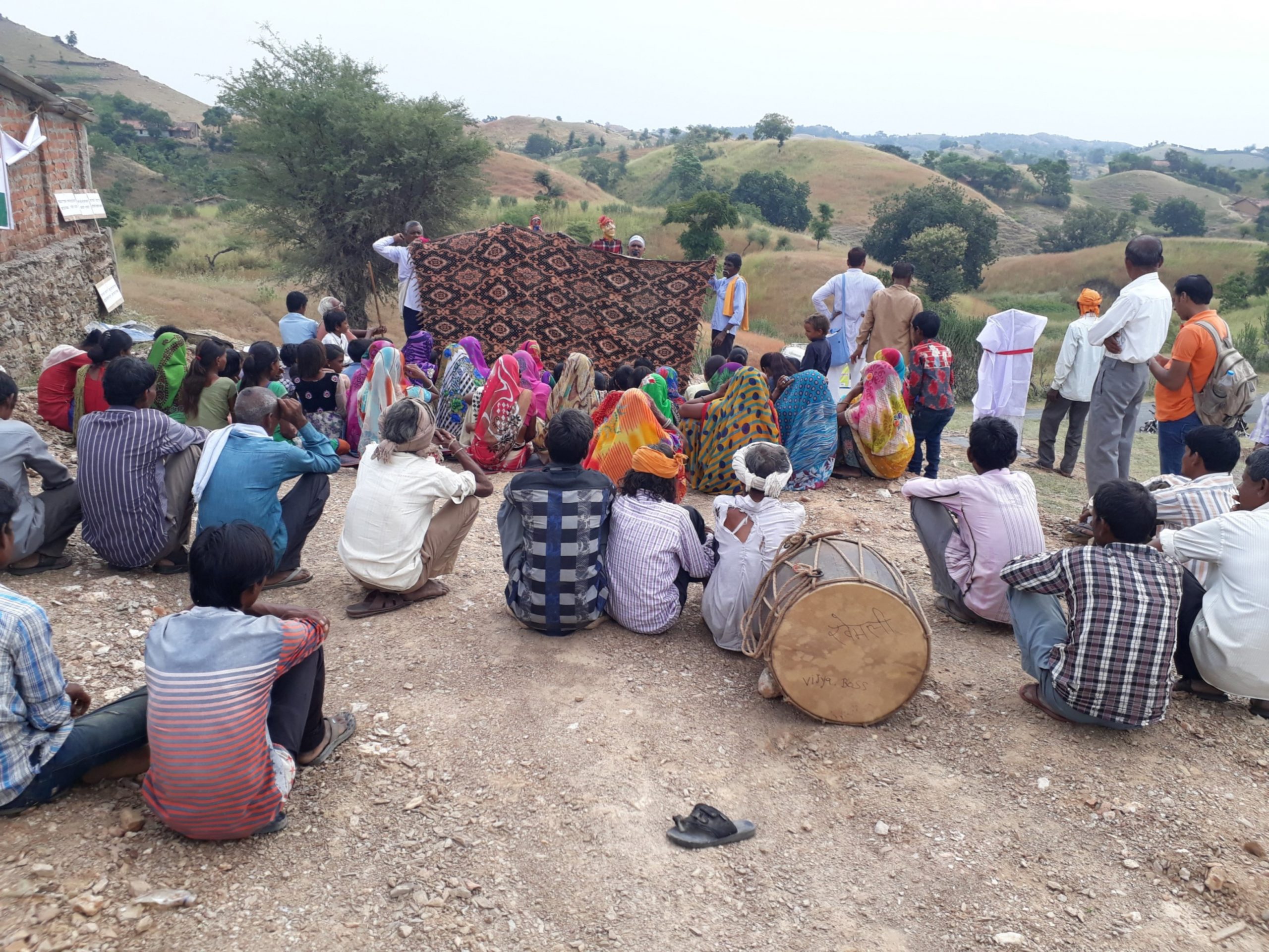 A group of people sitting in clusters -system of local self-government in India