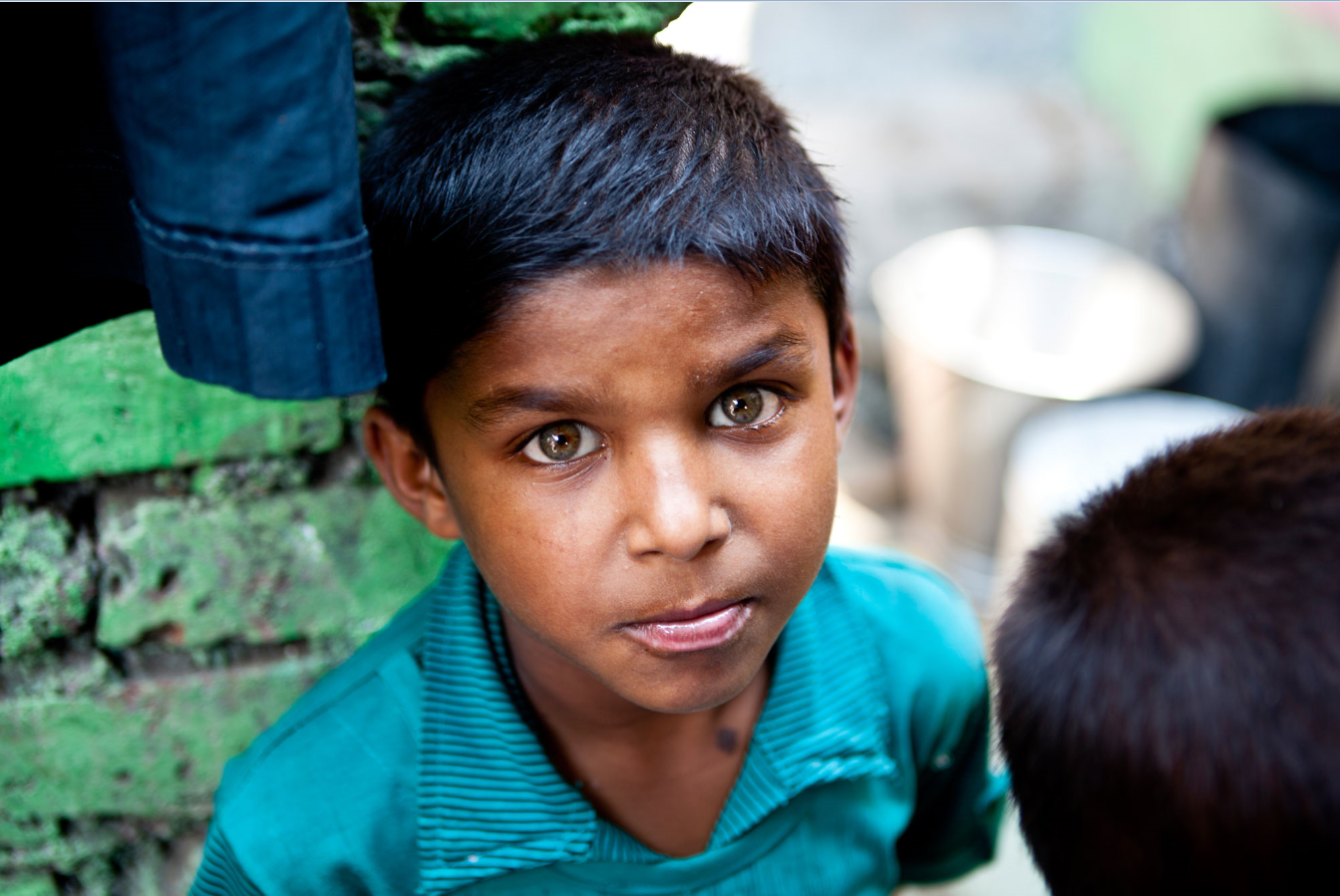 Boy standing in a village looking at the camera - young men. To empower young women, we need focus on the 200 million young men of India with as much urgency. India needs to redefine its masculinity if it wants an equal society.