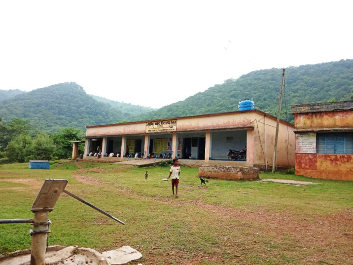 A boy walks past a school