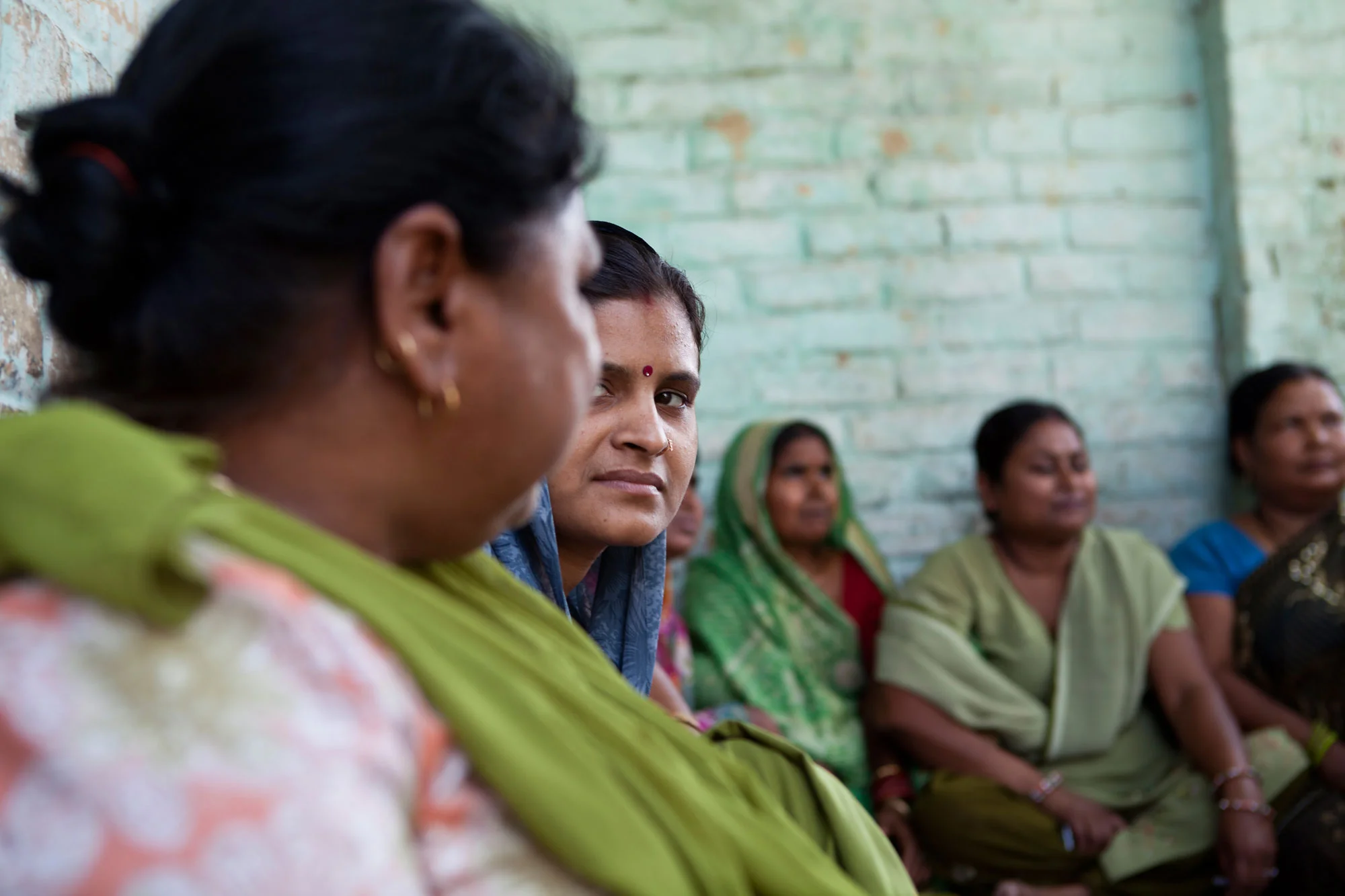 Closeup of women sitting next to each other- Photo courtesy: Charlotte Anderson