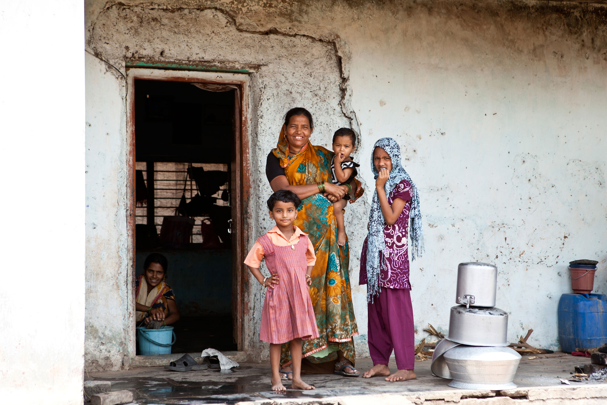 Mother and children standing outside a toilet on World Toilet Day