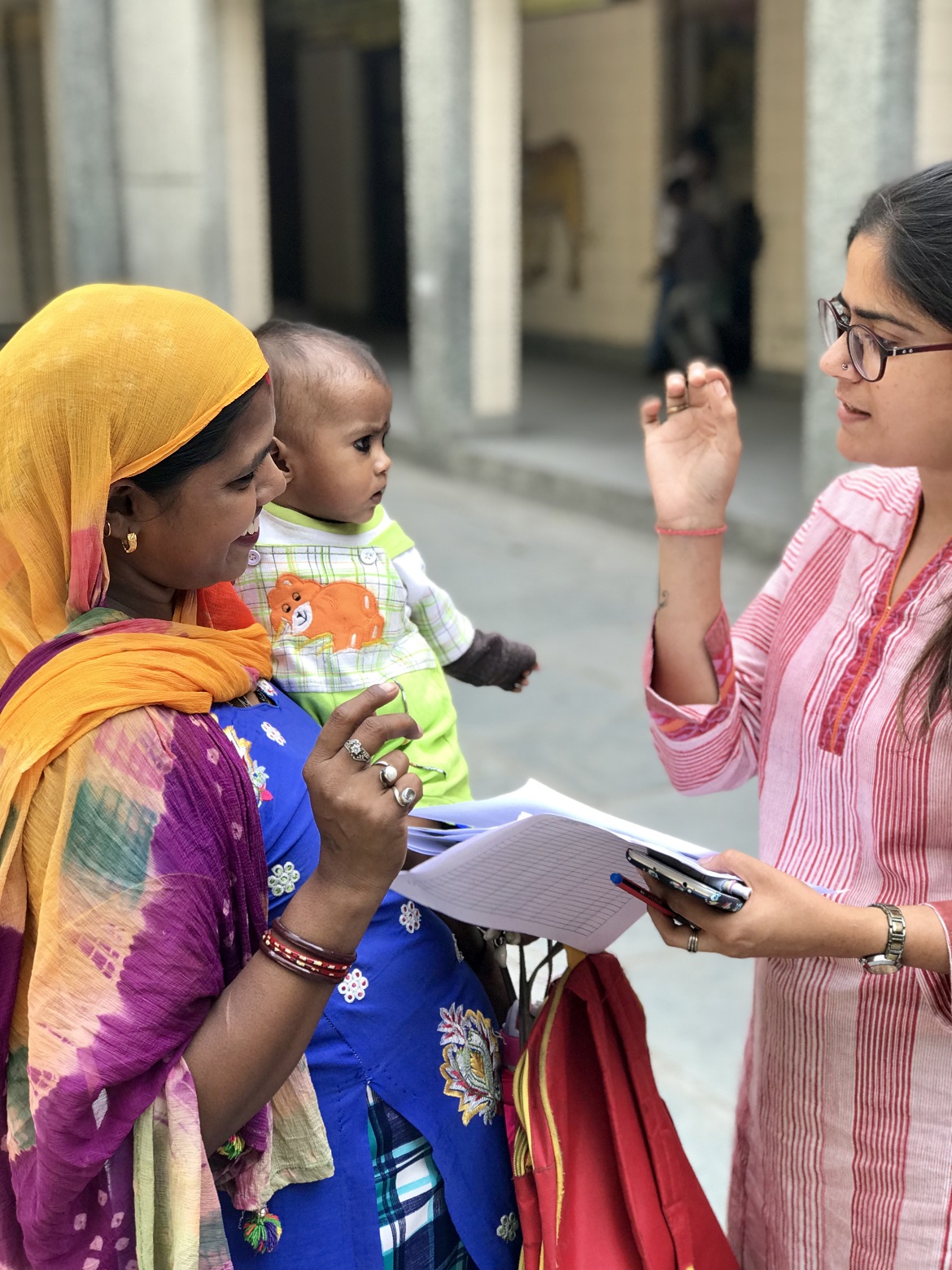 A woman explaining something to a village mother