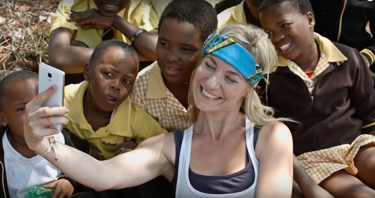 Volunteer taking a selfie with boys