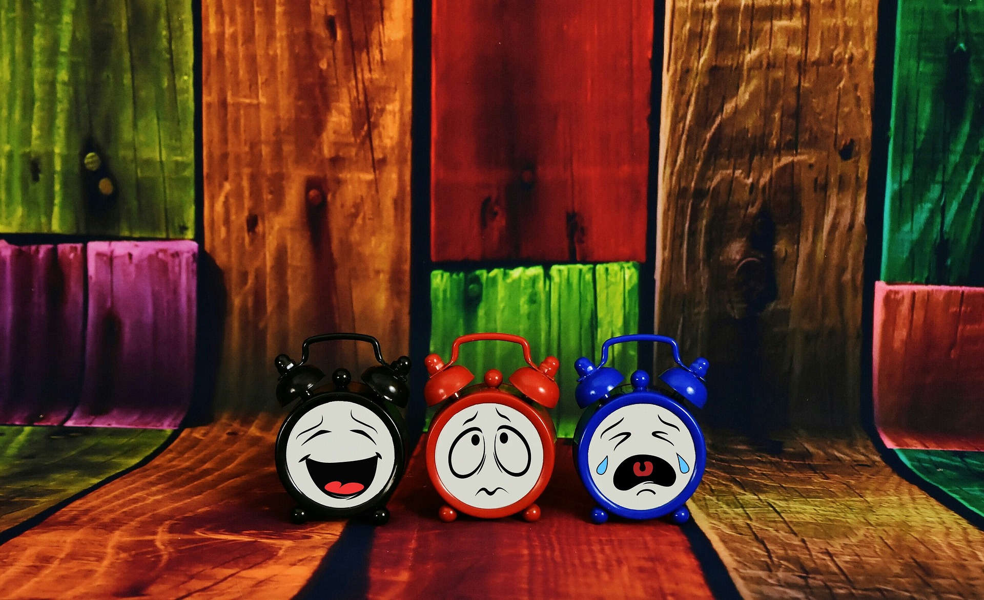 3 alarm clocks, each having different expressions