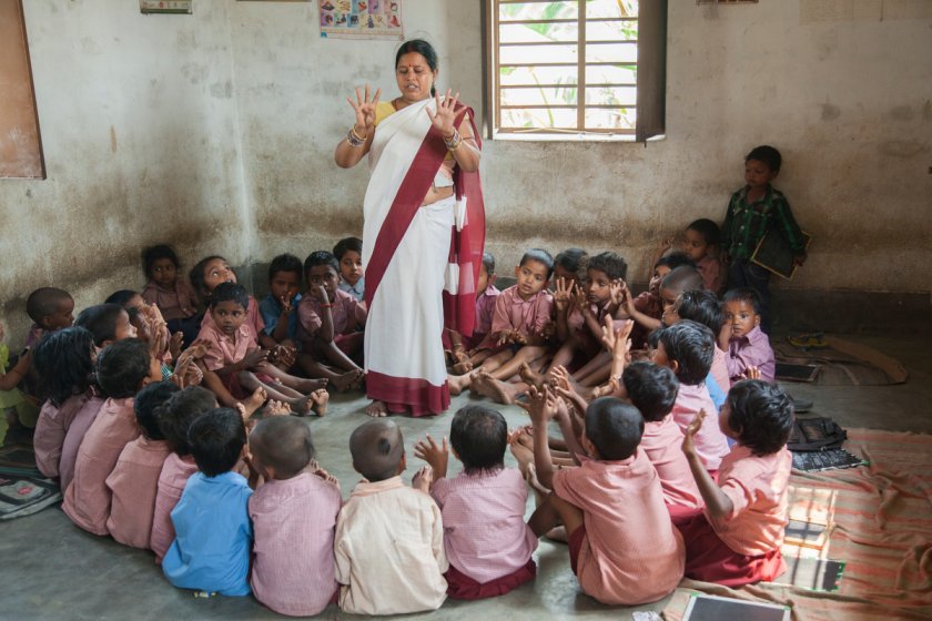 anganwadi worker teaching children - primary education