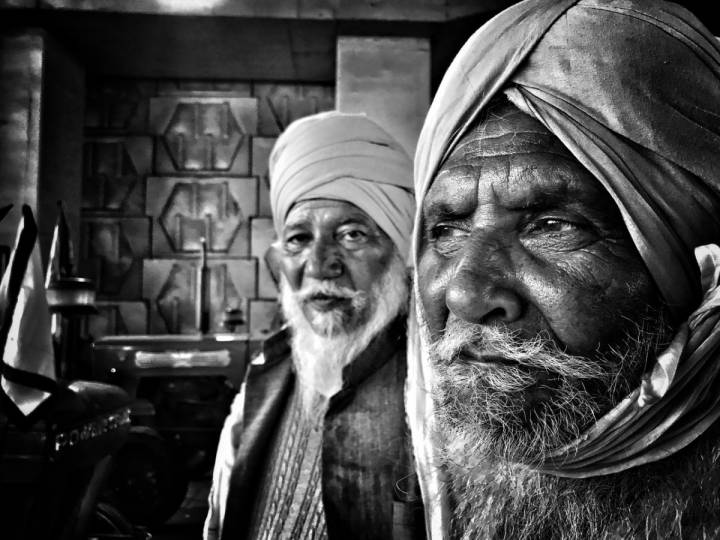 Close up of two bearded men wearing turbans- farmers protest