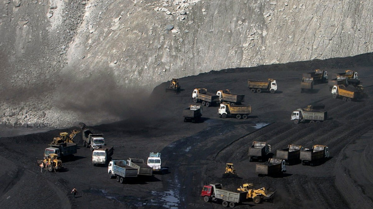 Trucks on a coal reserve in India-Adivasi-Reuters