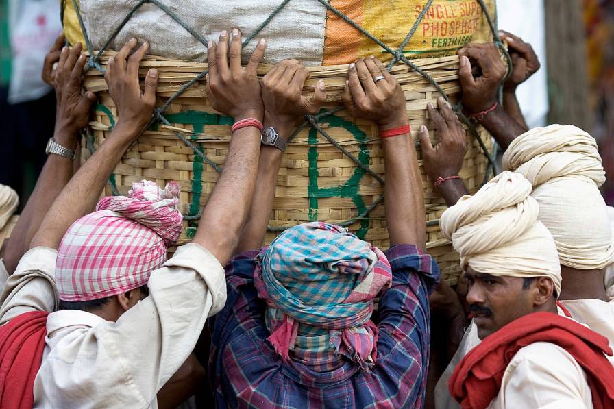 coolies pushing a heavy load in kolkata-informal workers