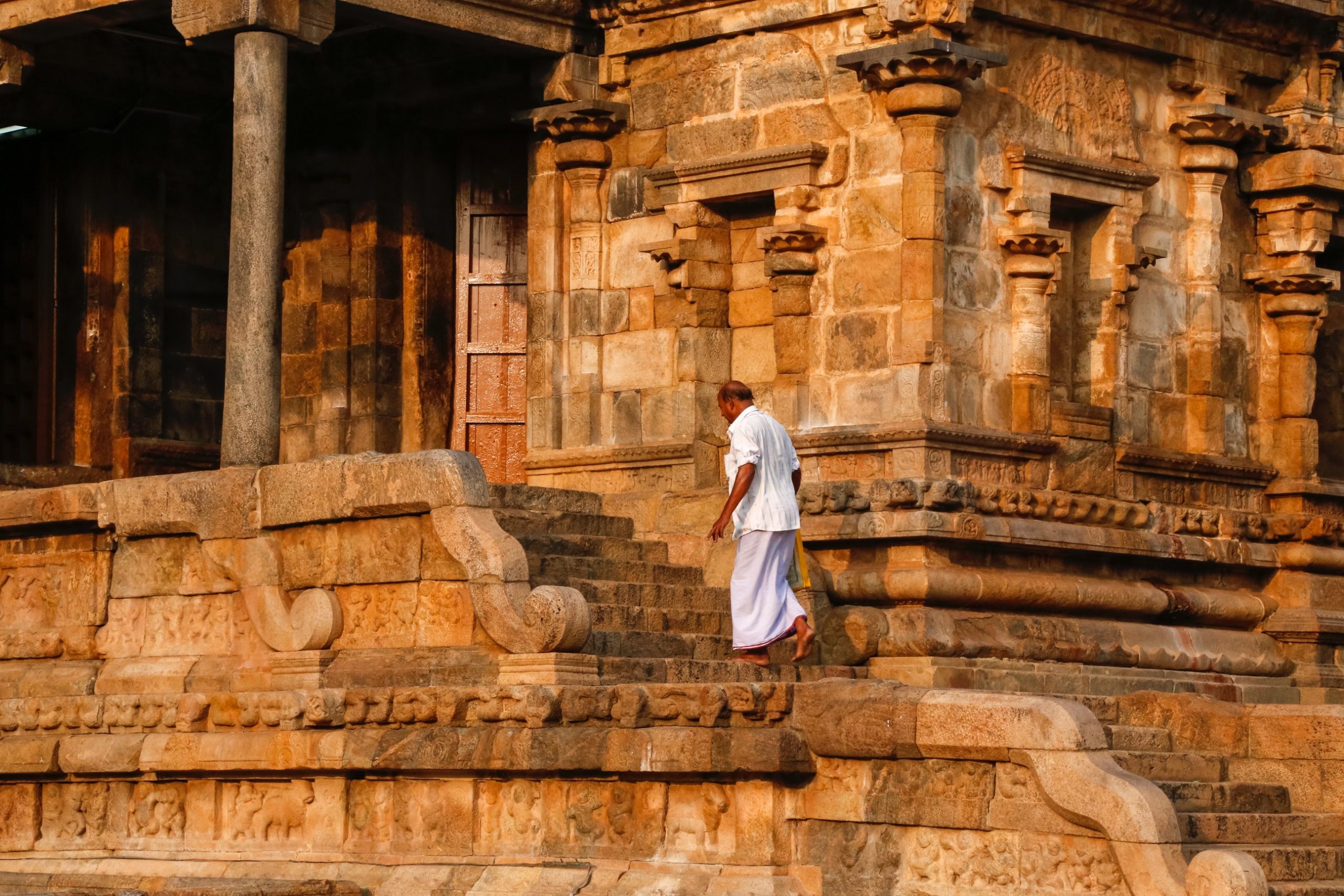 A man walking near a temple/fort