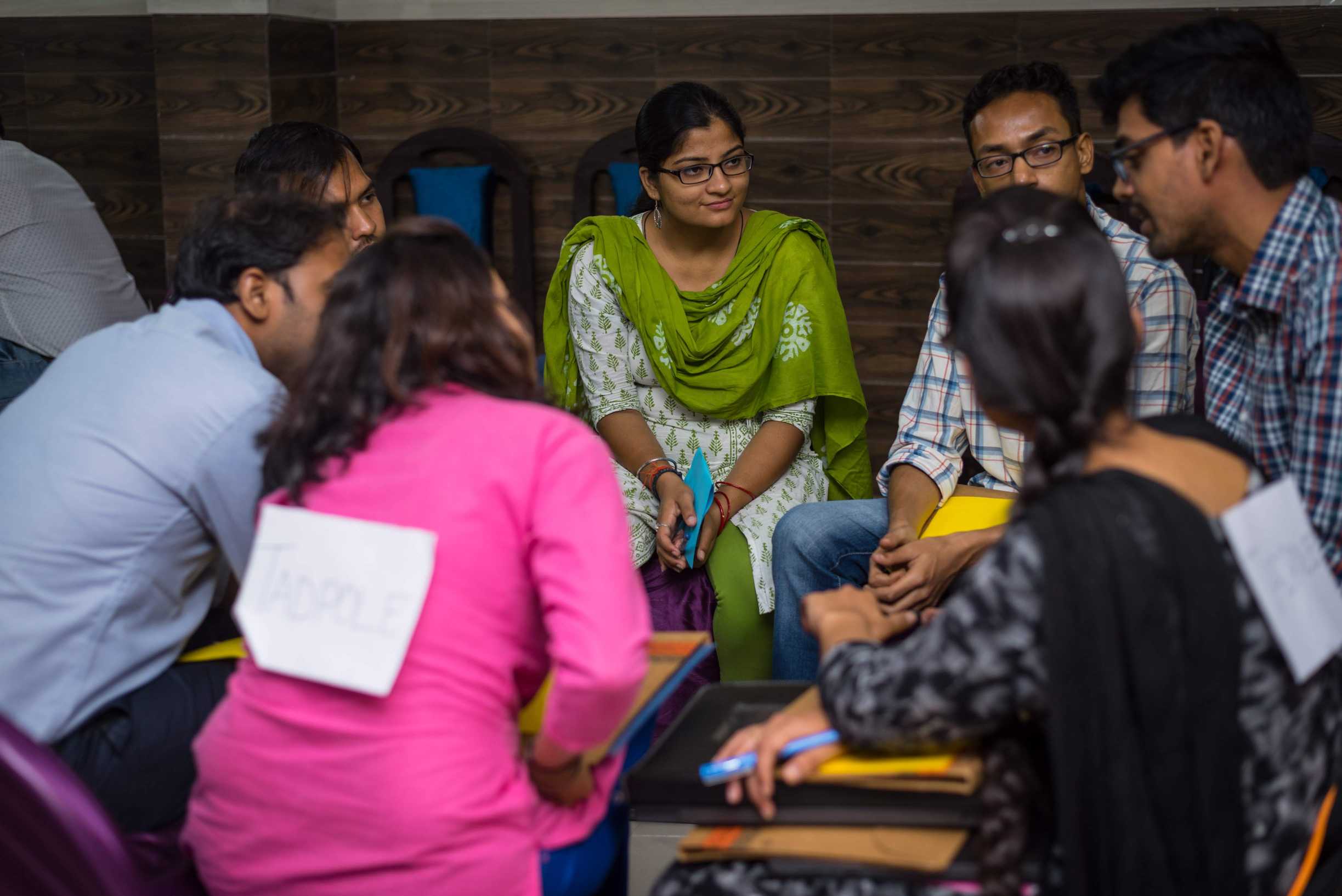 Woman talking with young professionals sitting around a table