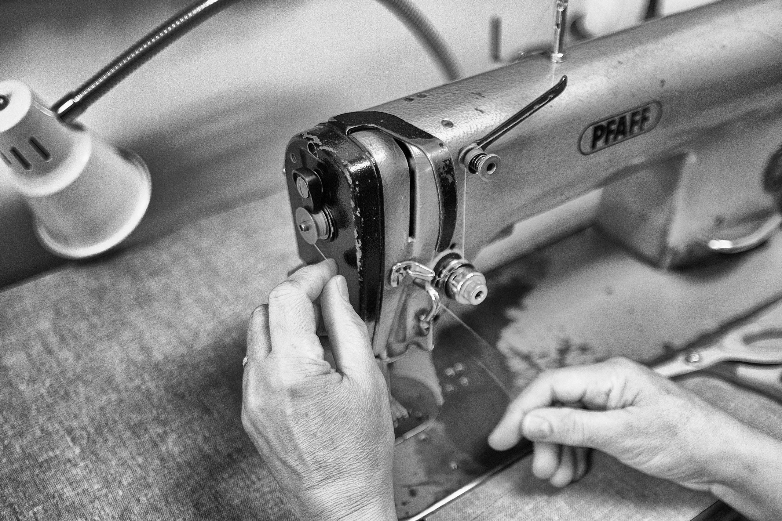 hands working on a tailoring machine-skilling