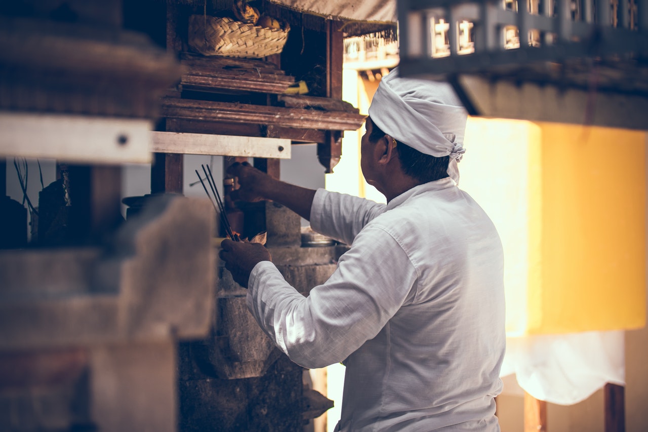 A man holding an agarbatti