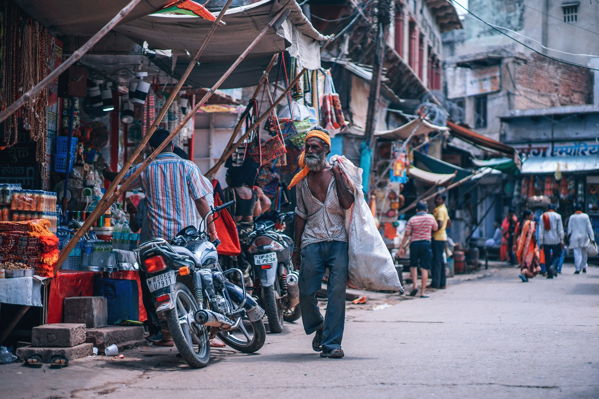 A poor man walking in the market place