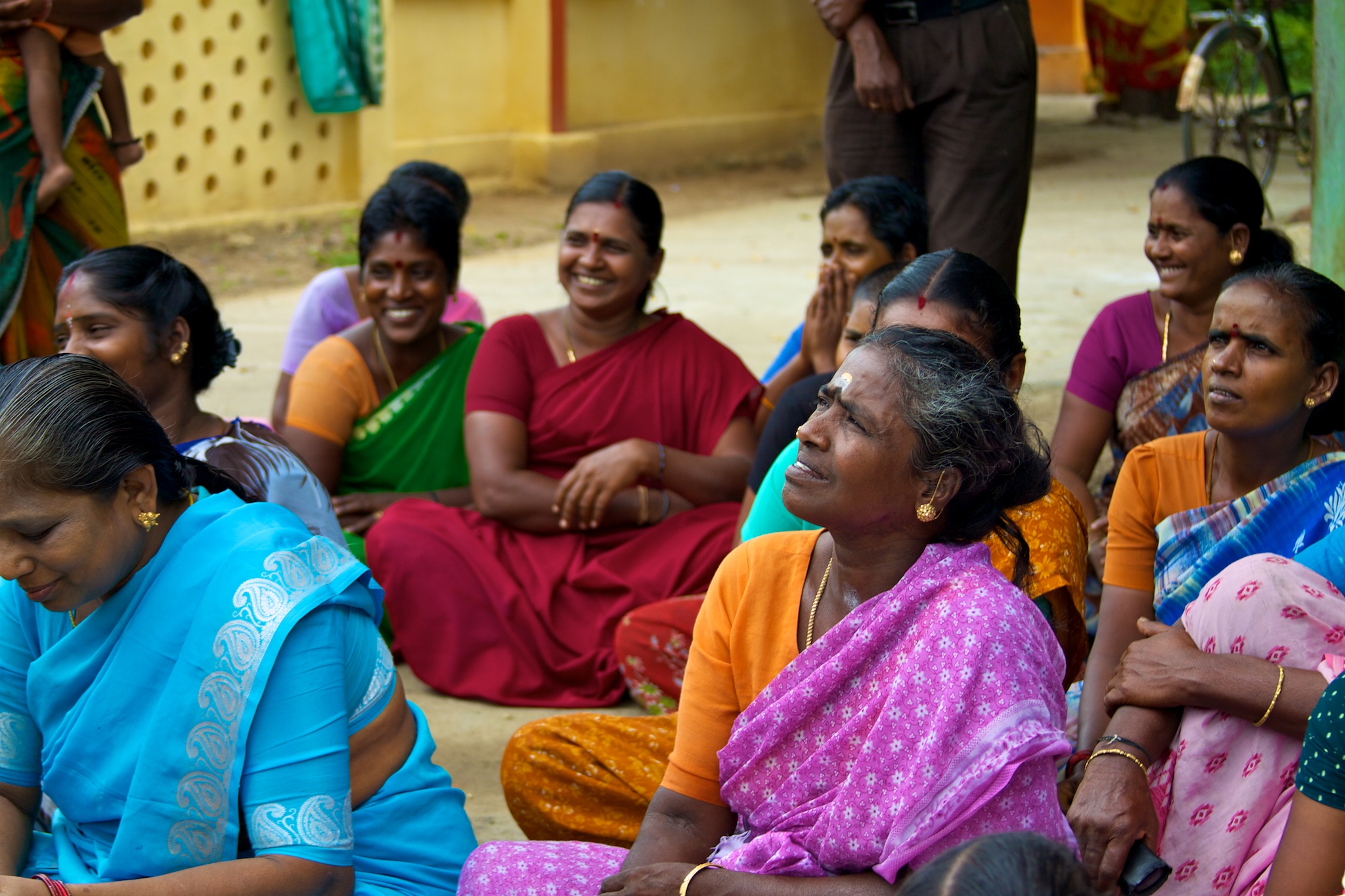 Several women in sarees, talking and laughing