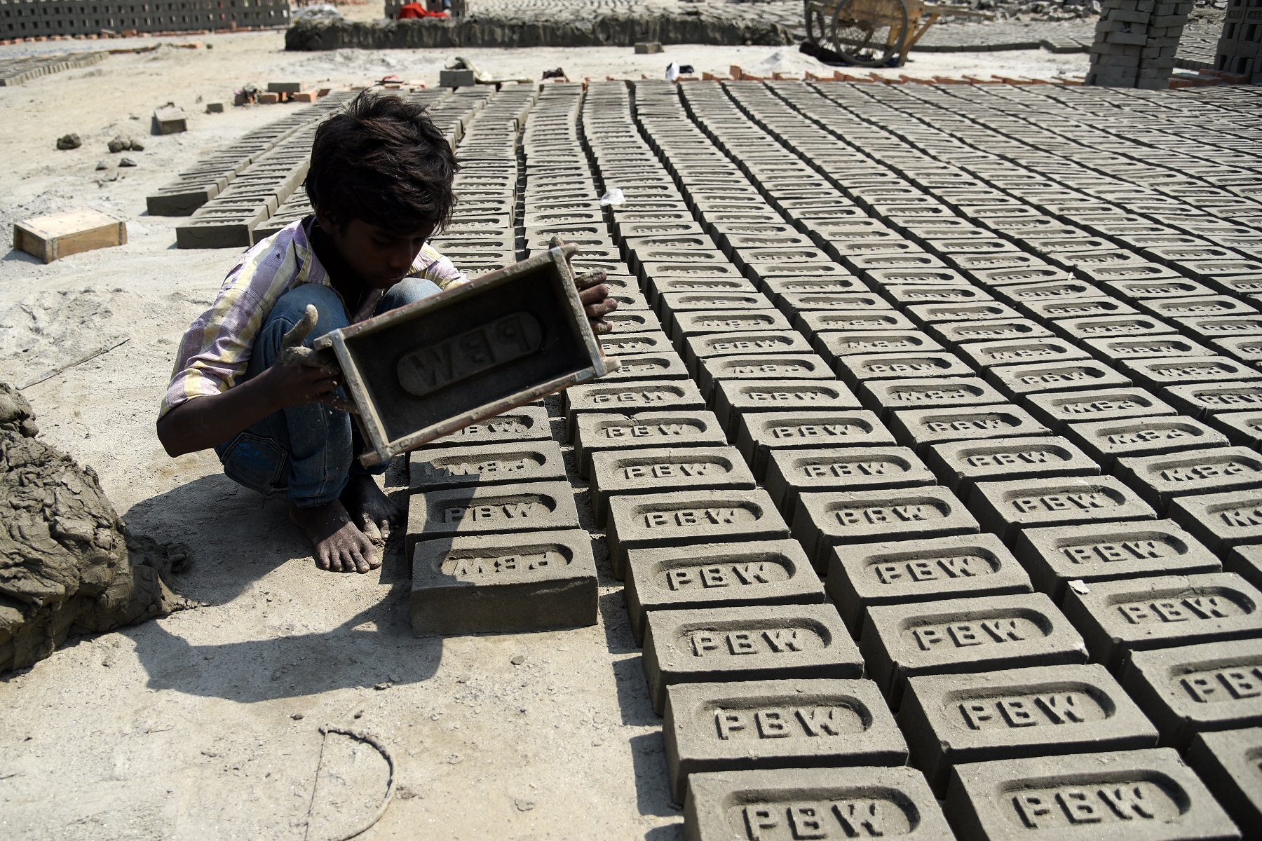 Pawan Kumar a young Indian boy moulds up to 200-300 bricks a day