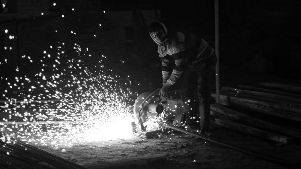 Migrant construction workers in Lucknow welding on site