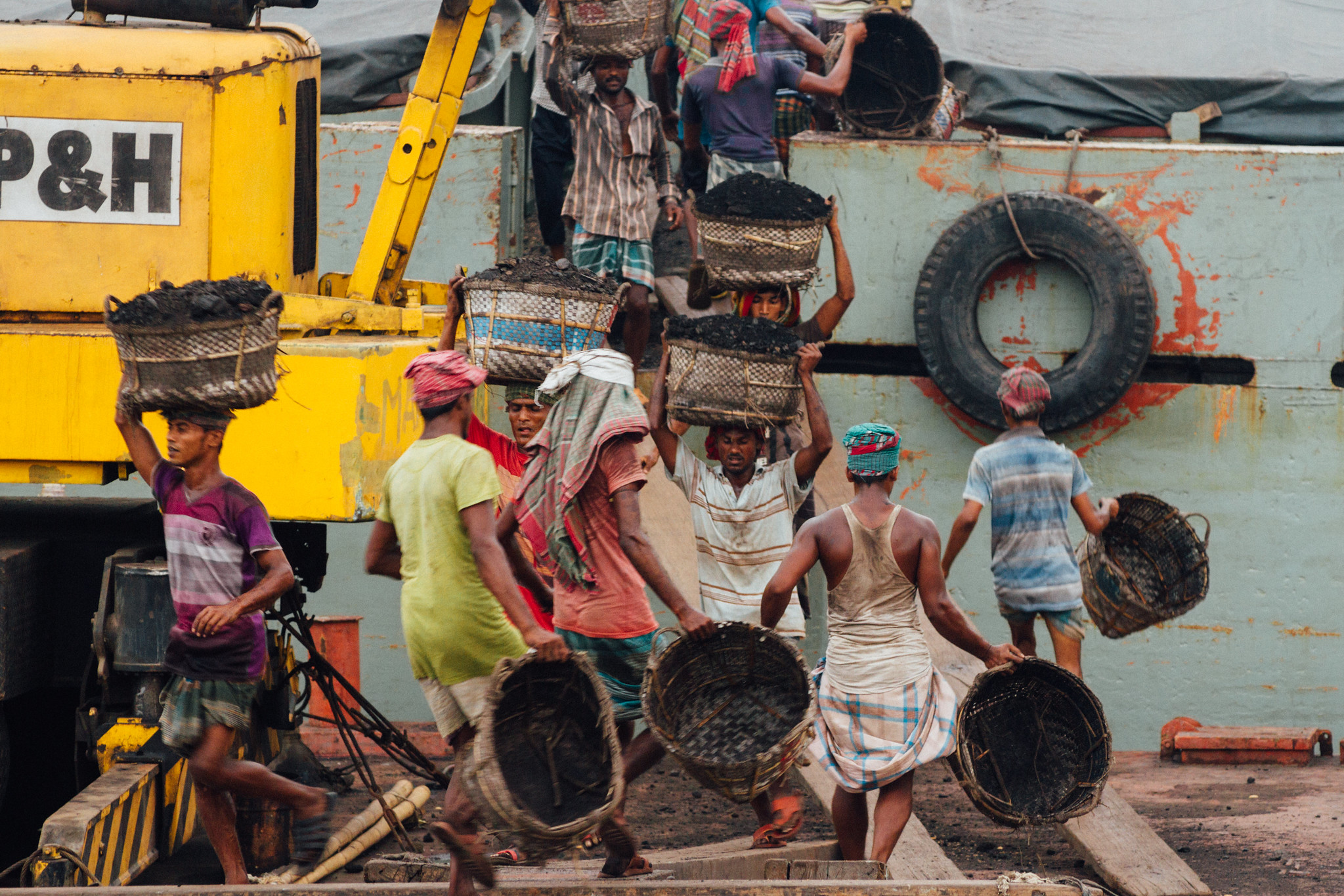 Workers unloading coal from a truck-coal mining