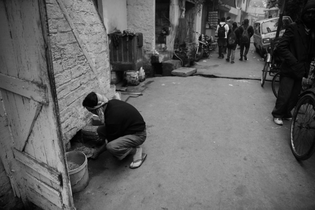 man cleaning waste 