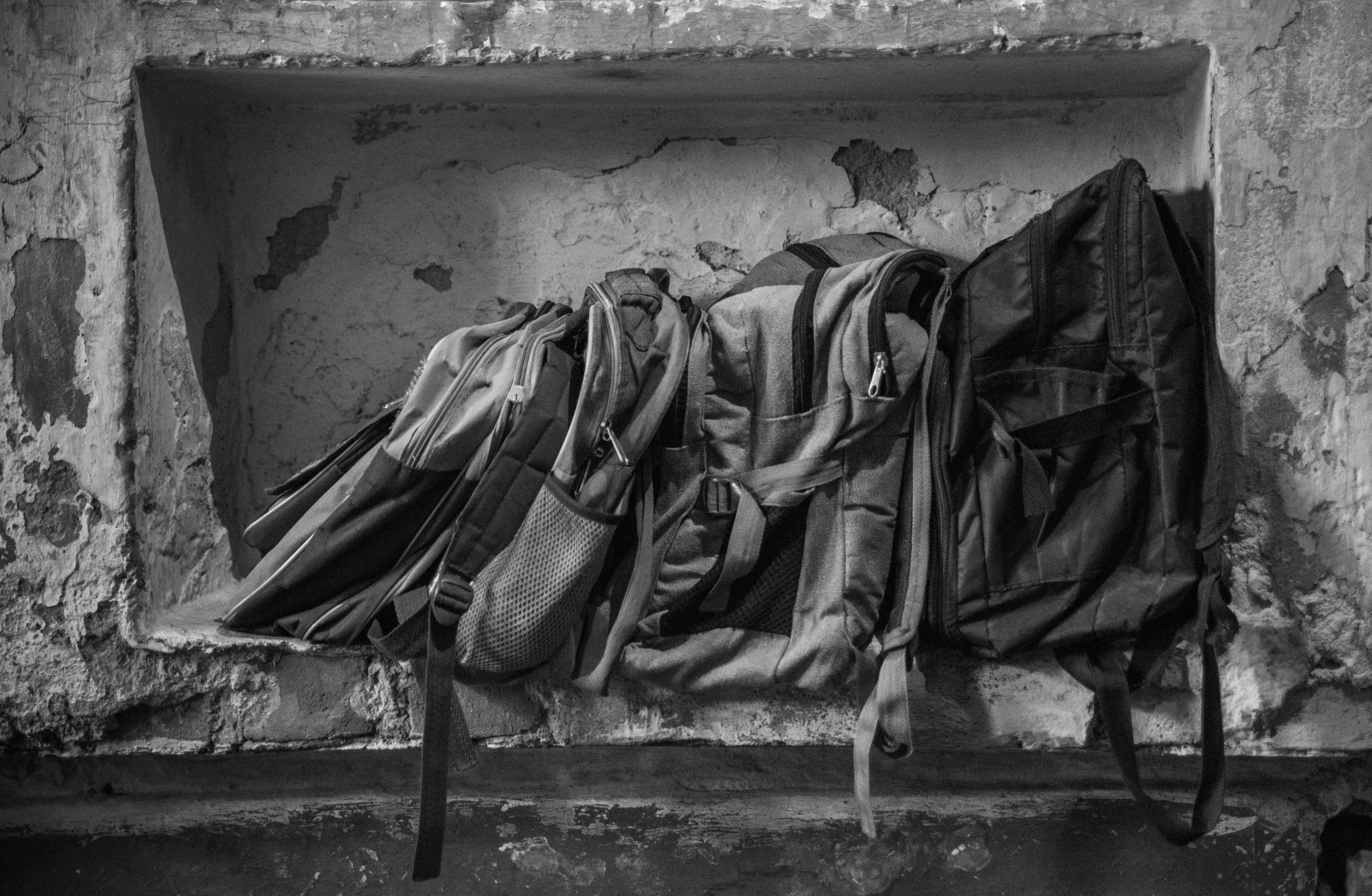 bags lined up on wall 