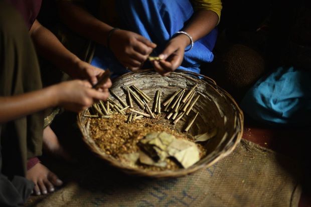 Indian woman and child rolling bidis