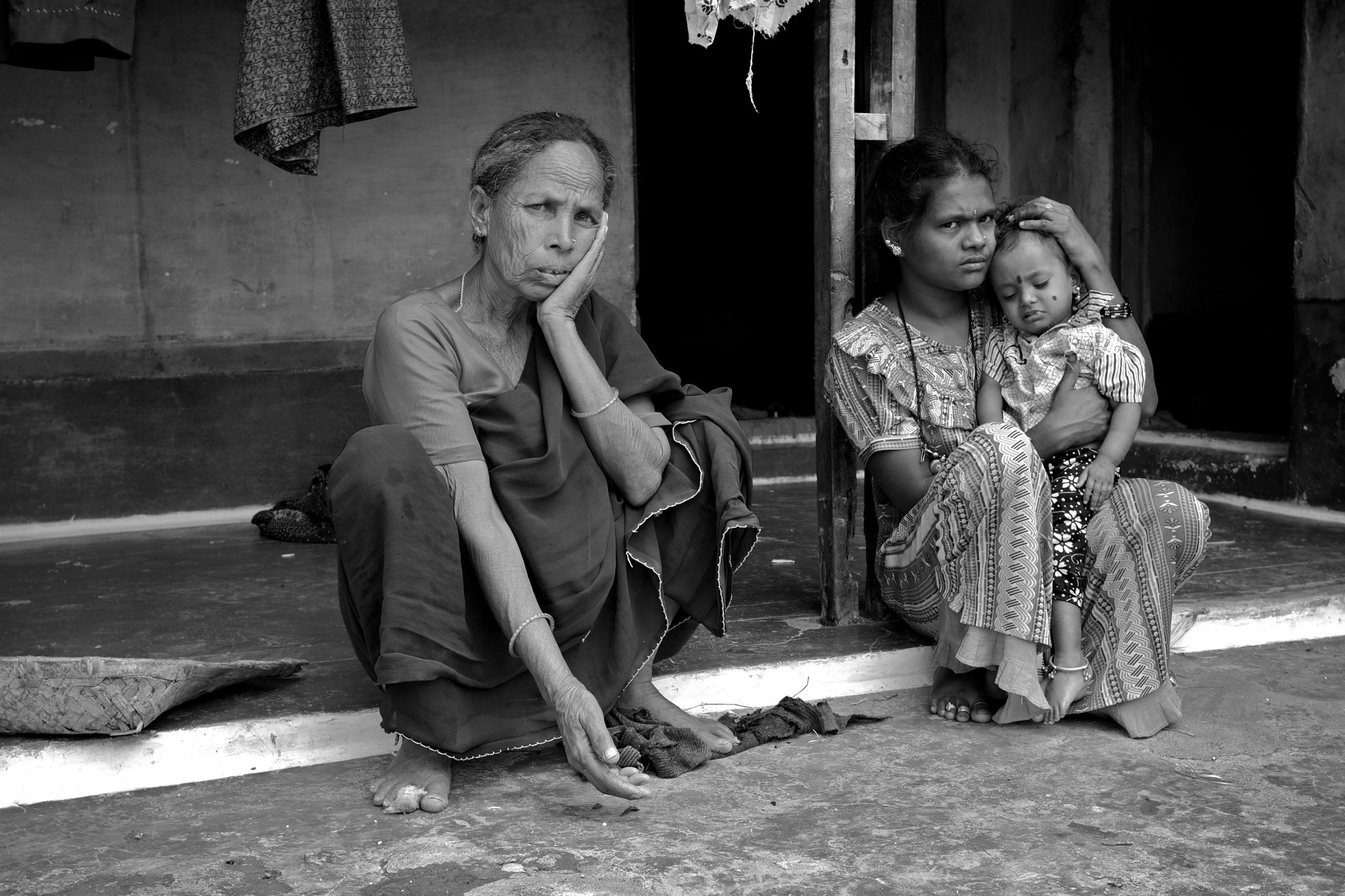 Indian women sitting outside their house-women and development