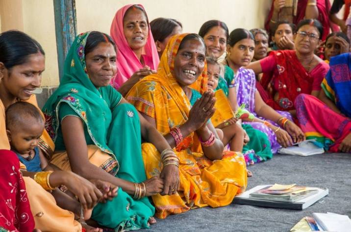 Women sitting next to each other in a row-women