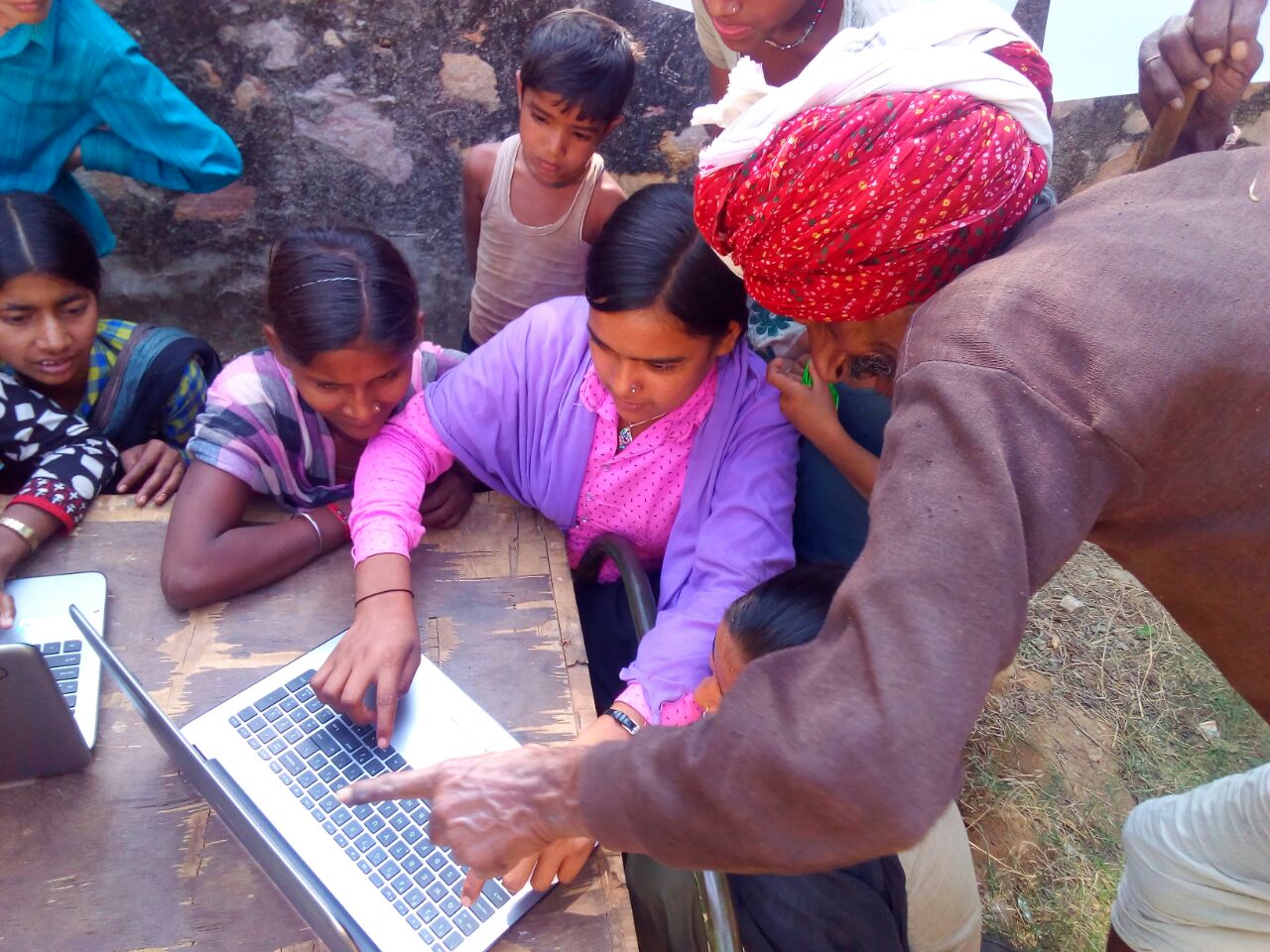 GSK parents in school looking at what their children are learning_rural education