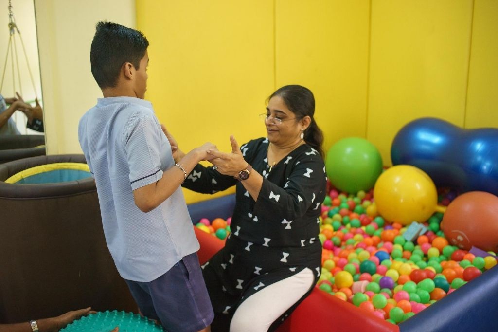 Occupational therapist Rashmi Desai in a playroom with a child with disability. She has worked with children for over two decades, but due to COVID-19, she has had to start imparting therapy from a distance