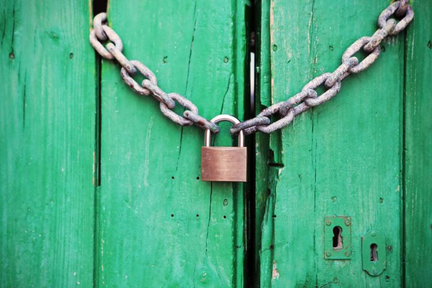 Green door locked with a padlock