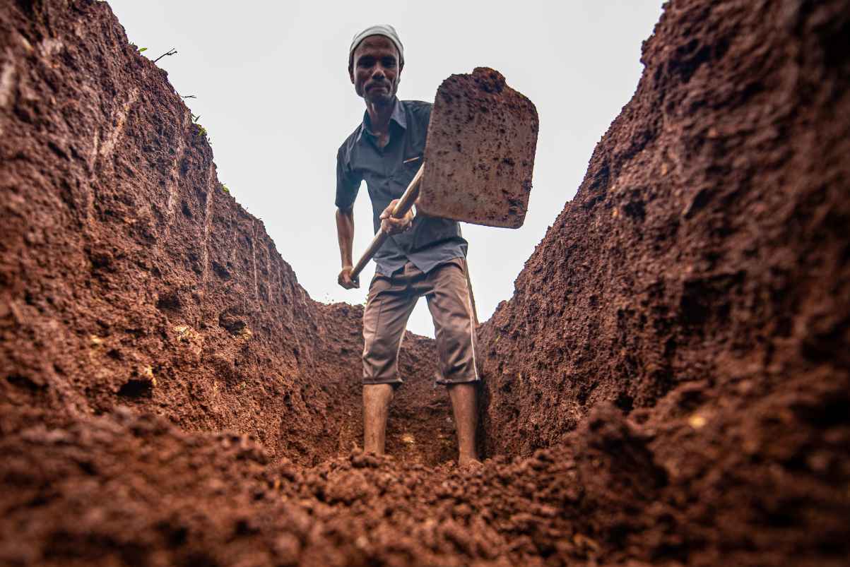 man digging a pit-rural employment