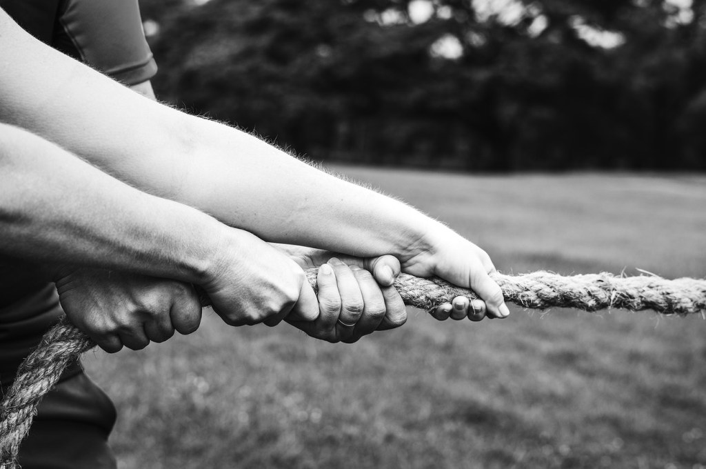 Hands pulling on a rope-nonprofits and COVID-19 relief