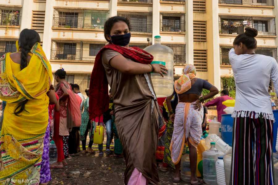 Image 9_ woman wearing a mask carrying a water container-water for all-picture courtesy Suraj Katra