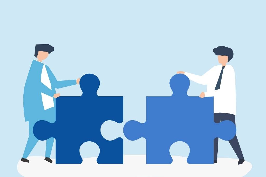 colleagues-connecting-jigsaw-pieces-together-social sector government