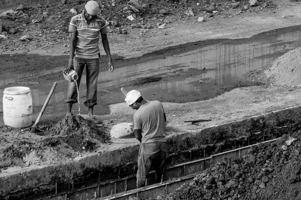 two construction workers working on a site-BOCW card