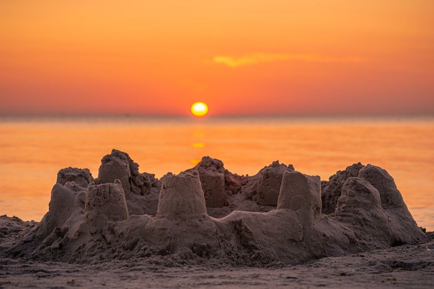 Image of a sandcastle in the foreground-social impact-