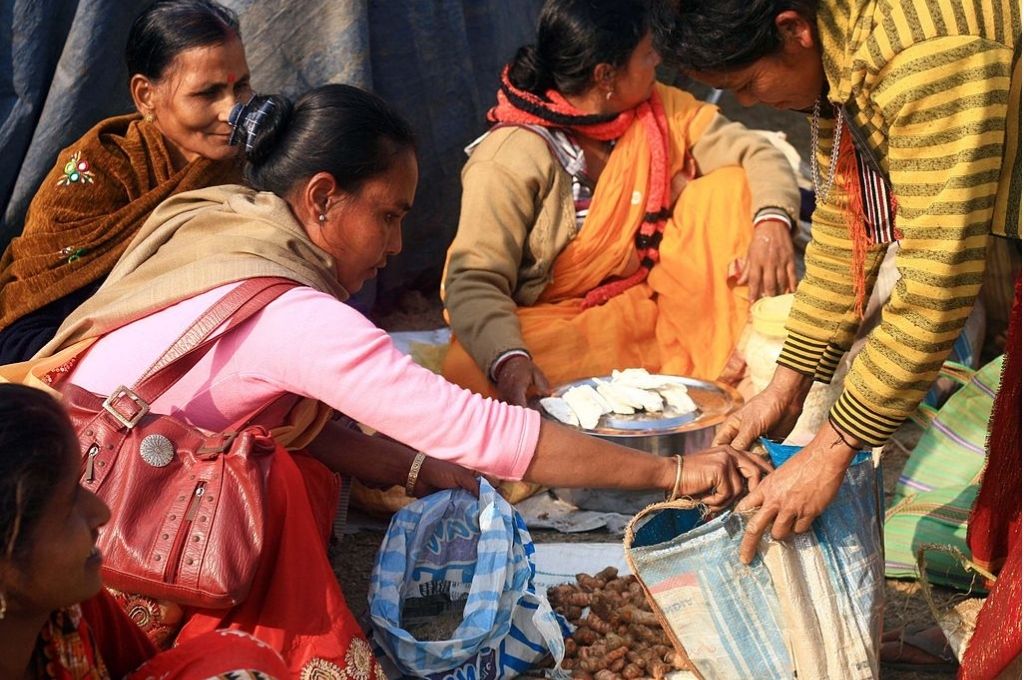 Women exchanging various goods at a fair-barter-rural communities