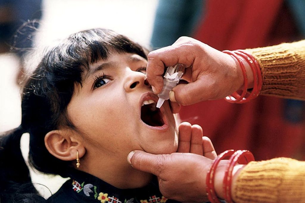 A young Indian girl being given the oral polio vaccine