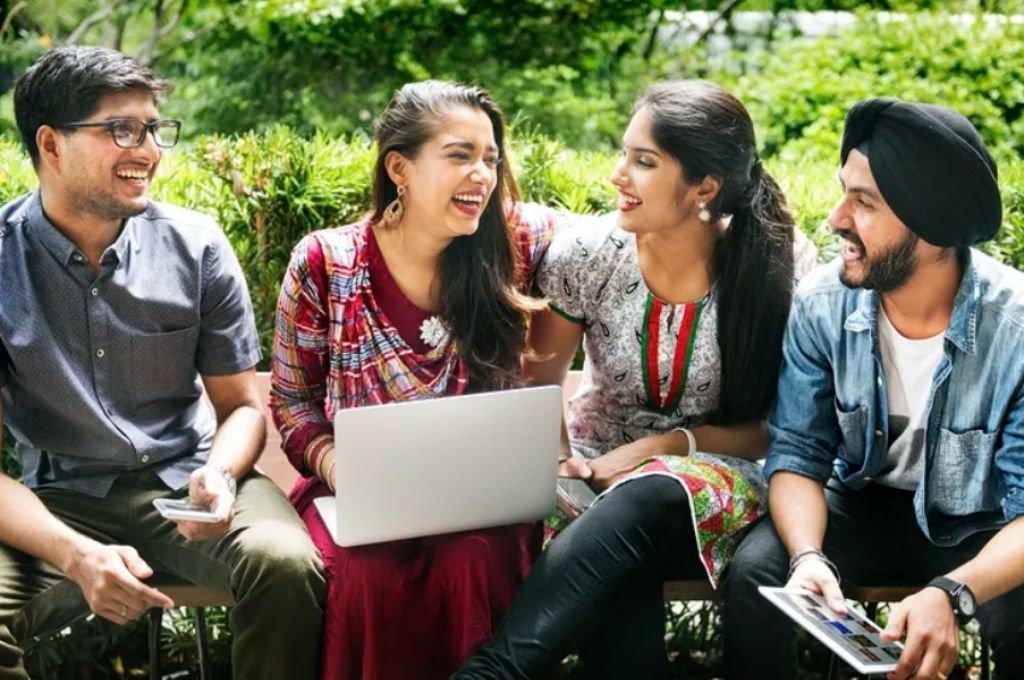 Young people sitting around, a girl who is sitting with her laptop-youth