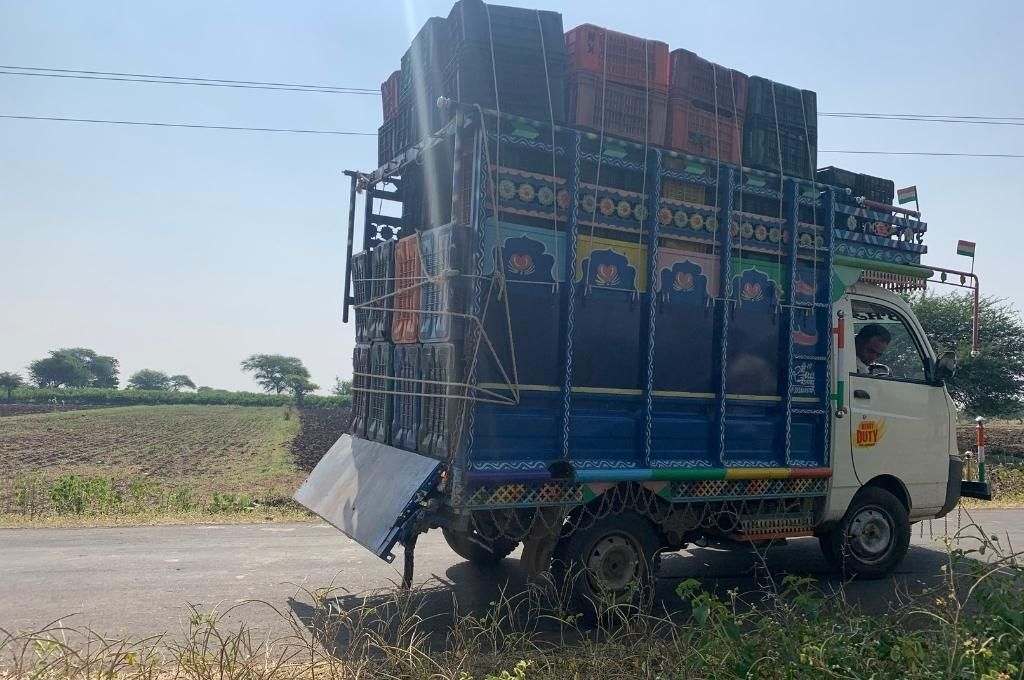 Crates of harvested tomatoes being transported on a vehicle-value chain