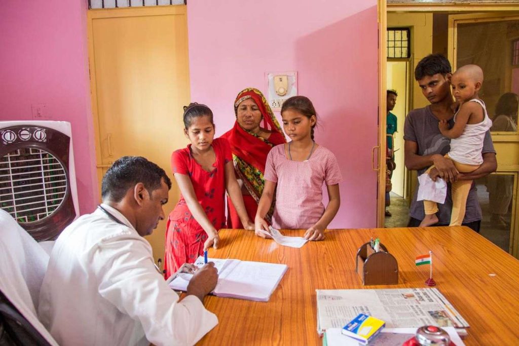 a doctor writing a prescription at a primary health centre - PHC