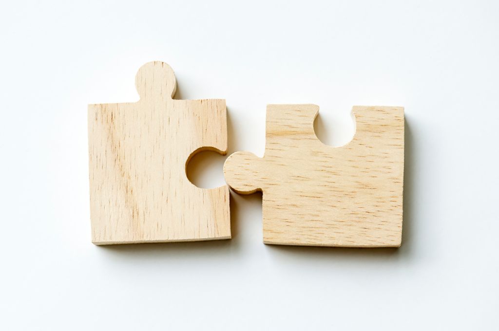 Two pieces of jigsaw puzzle coming together_individual giving