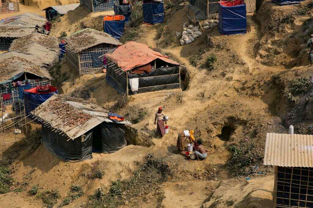 People working outside houses in a refugee camp_internally displaced persons