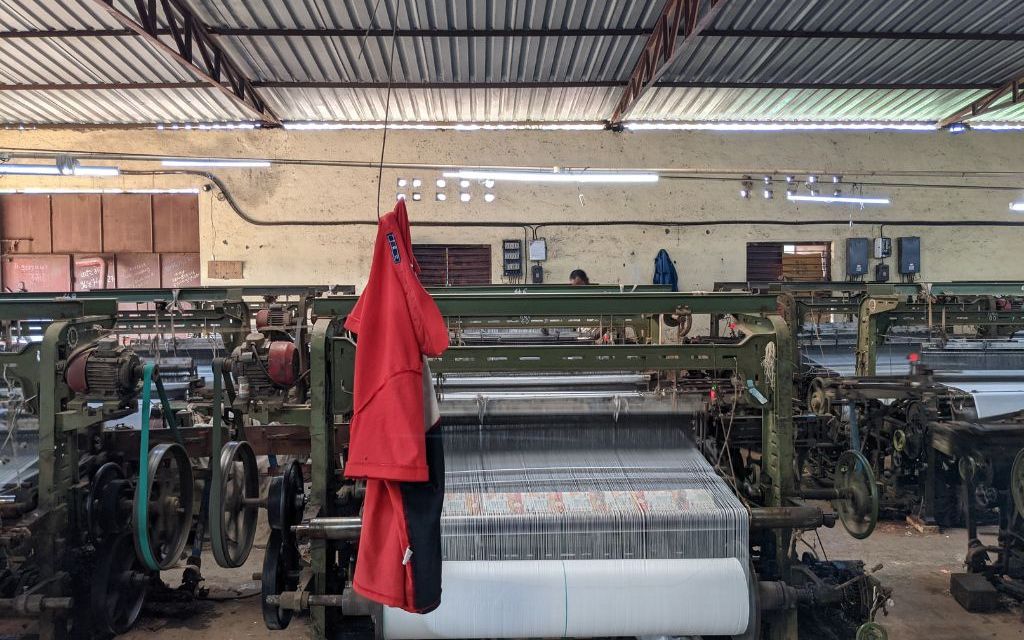 red jacket hanging on a machine-elderly workers